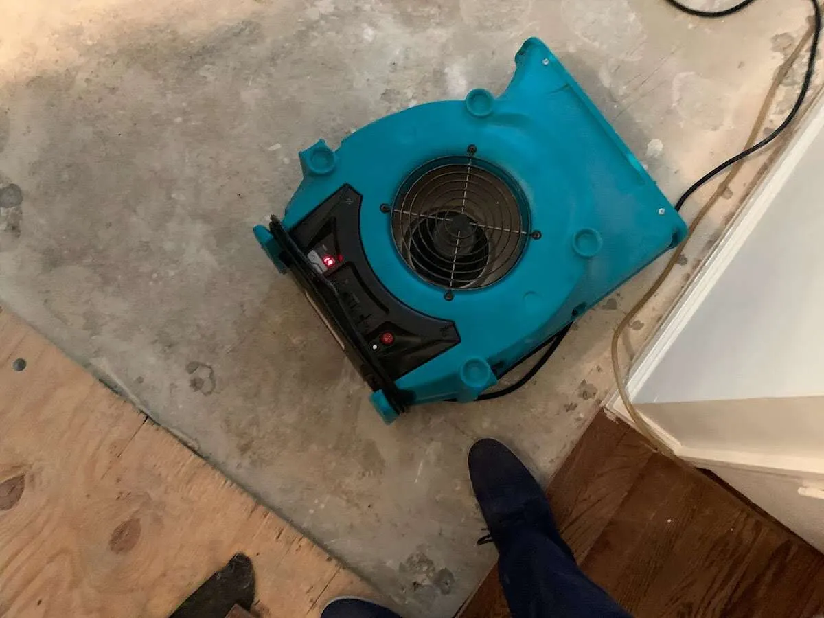 Air mover drying subfloor during Commercial Water Damage Restoration in Yuma
